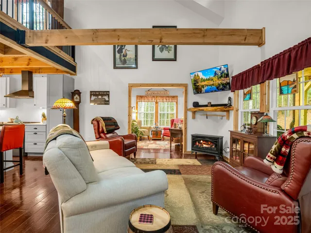 a living room with furniture fireplace and a large window