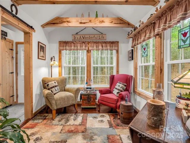 a living room with furniture and a floor to ceiling window