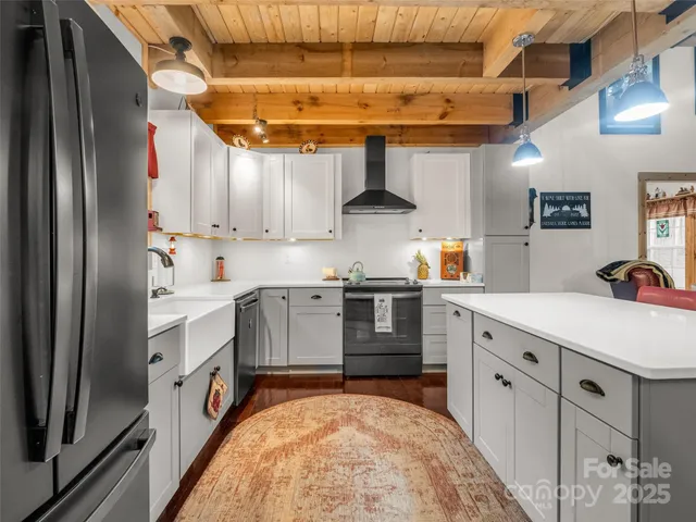 a kitchen with white cabinets and white appliances