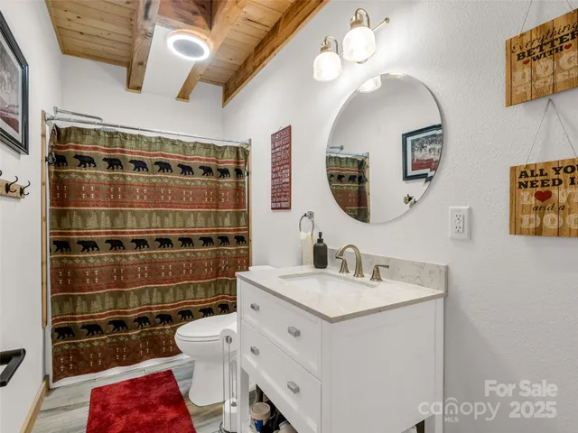 a bathroom with a sink a toilet and a mirror