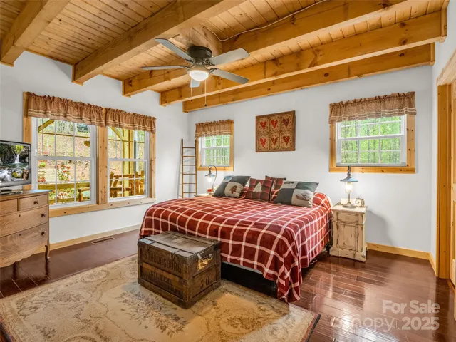 a bedroom with bed and wooden floor