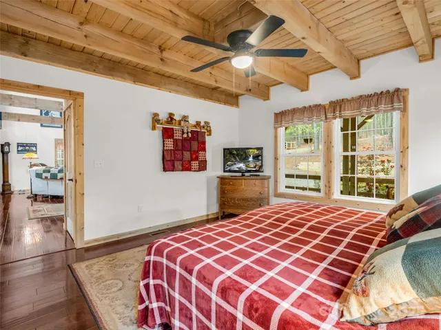 a bedroom with a large bed and a large window