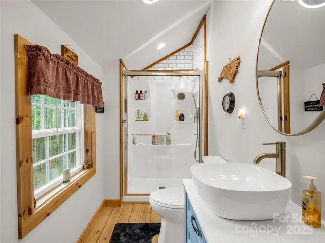 a bathroom with a toilet sink and shower