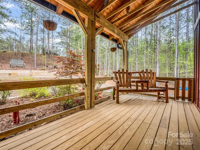 a roof deck with wooden floor and outdoor seating