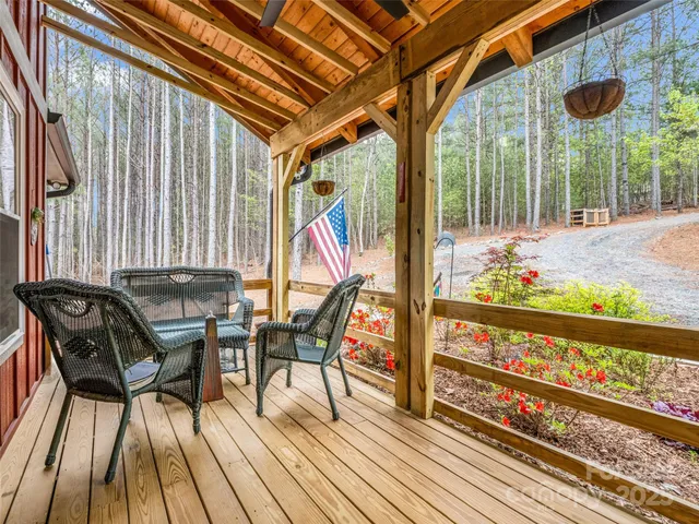 a view of a chairs and table in patio with wooden fence