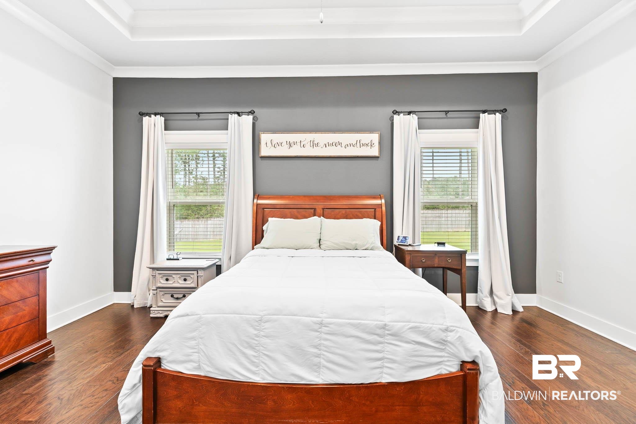 12785 Warbler Street Daphne, AL 36527 - Photo 15 of 53 Bedroom with dark wood-style flooring, a raised ceiling, and crown molding
