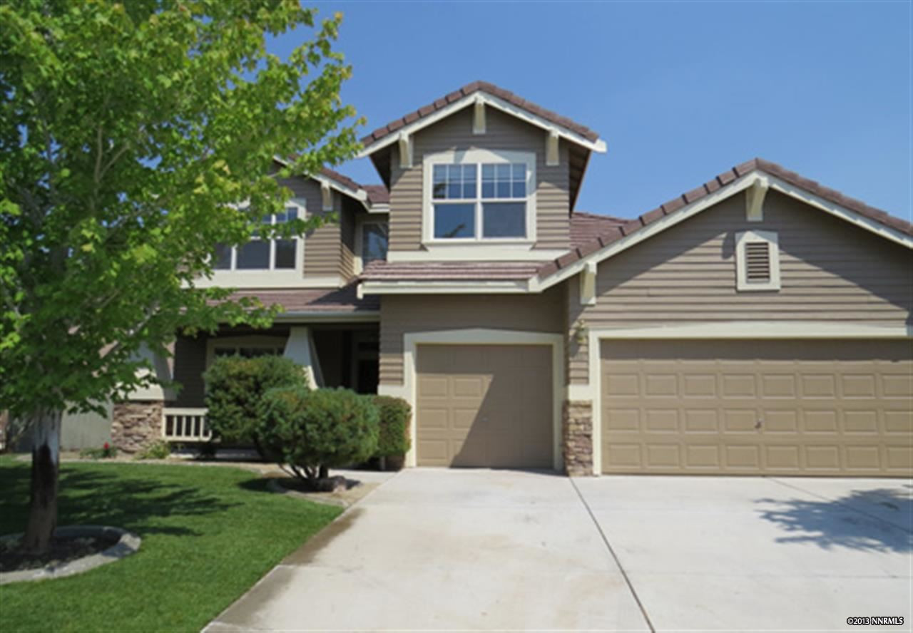 9520 Oakley Lane Reno, NV 89521 - Photo 1 of 1 a front view of a house with a yard and garage