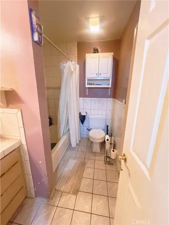 a bathroom with a sink a toilet and a shower