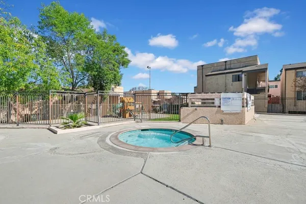 a view of a backyard with swimming pool and furniture