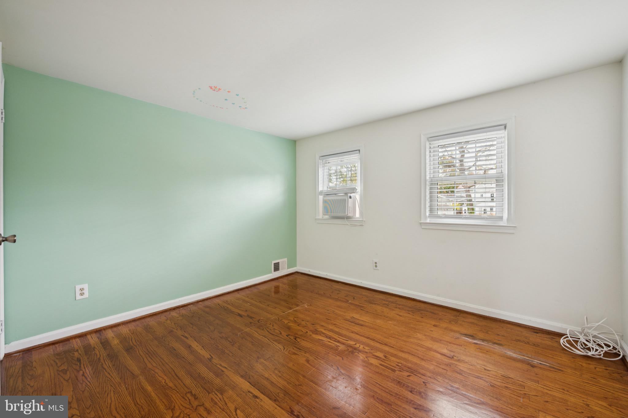 166 Ellis Street Haddonfield, NJ 08033 - Photo 21 of 25 an empty room with wooden floor and windows