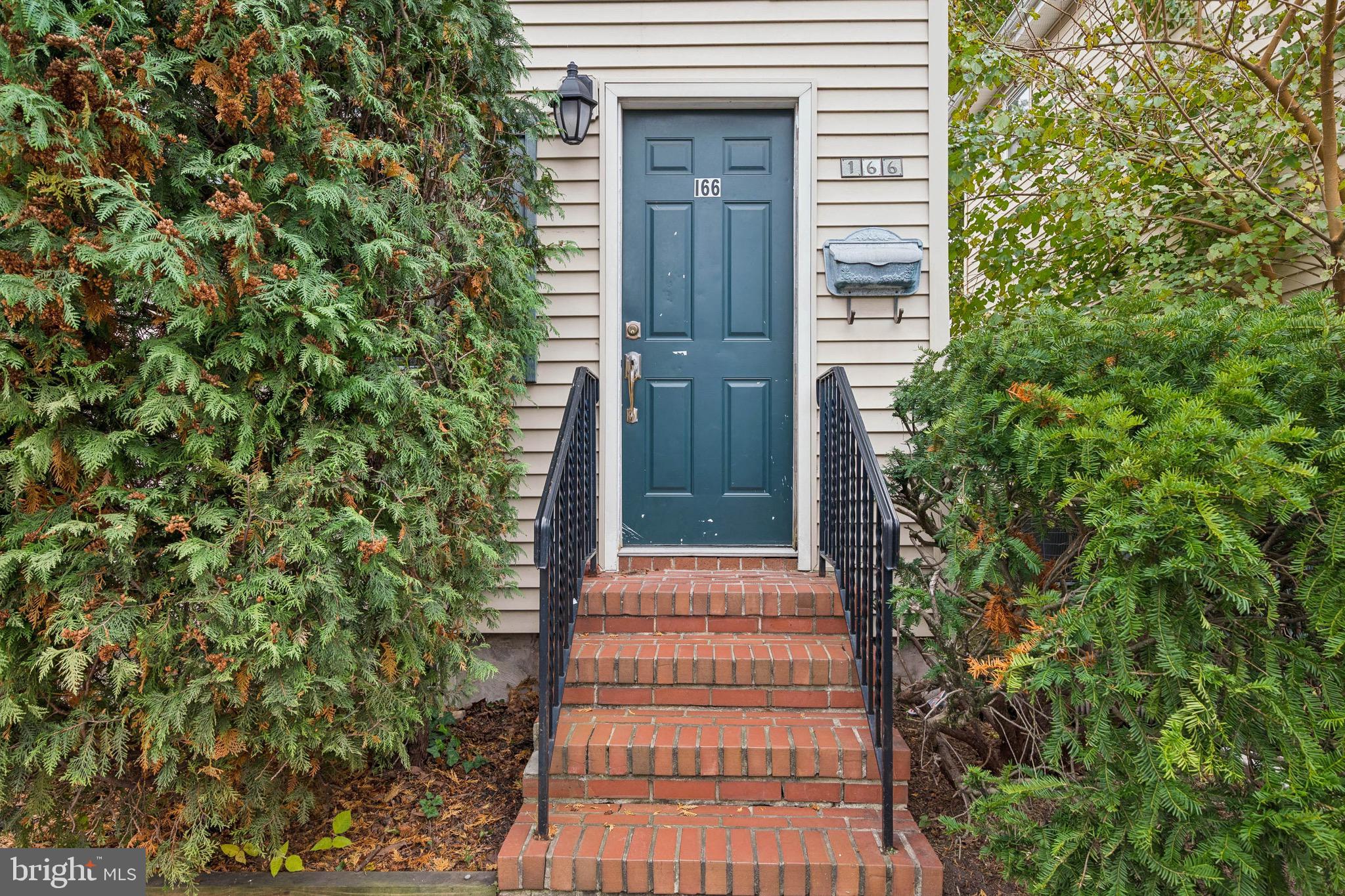 166 Ellis Street Haddonfield, NJ 08033 - Photo 3 of 25 a pathway of a house with potted plants