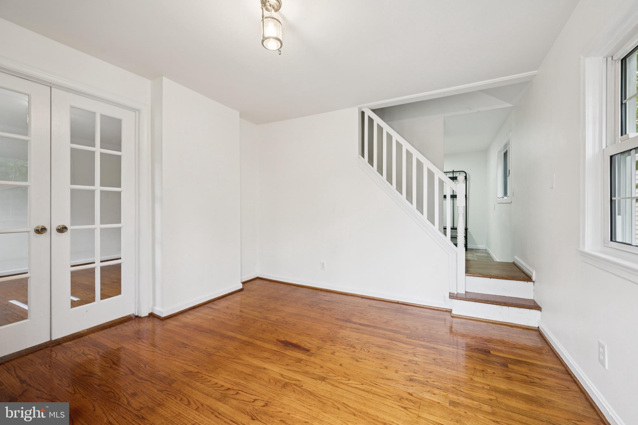 166 Ellis Street Haddonfield, NJ 08033 - Photo 5 of 25 a view of an entryway with wooden floor leading to a furnished livingroom and windows