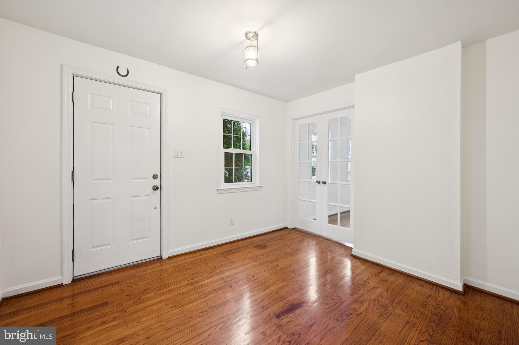 166 Ellis Street Haddonfield, NJ 08033 - Photo 6 of 25 an empty room with wooden floor and windows