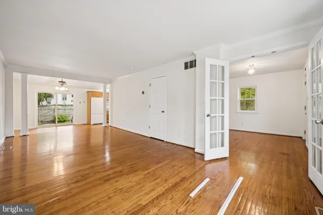 a view of empty room with wooden floor and fireplace