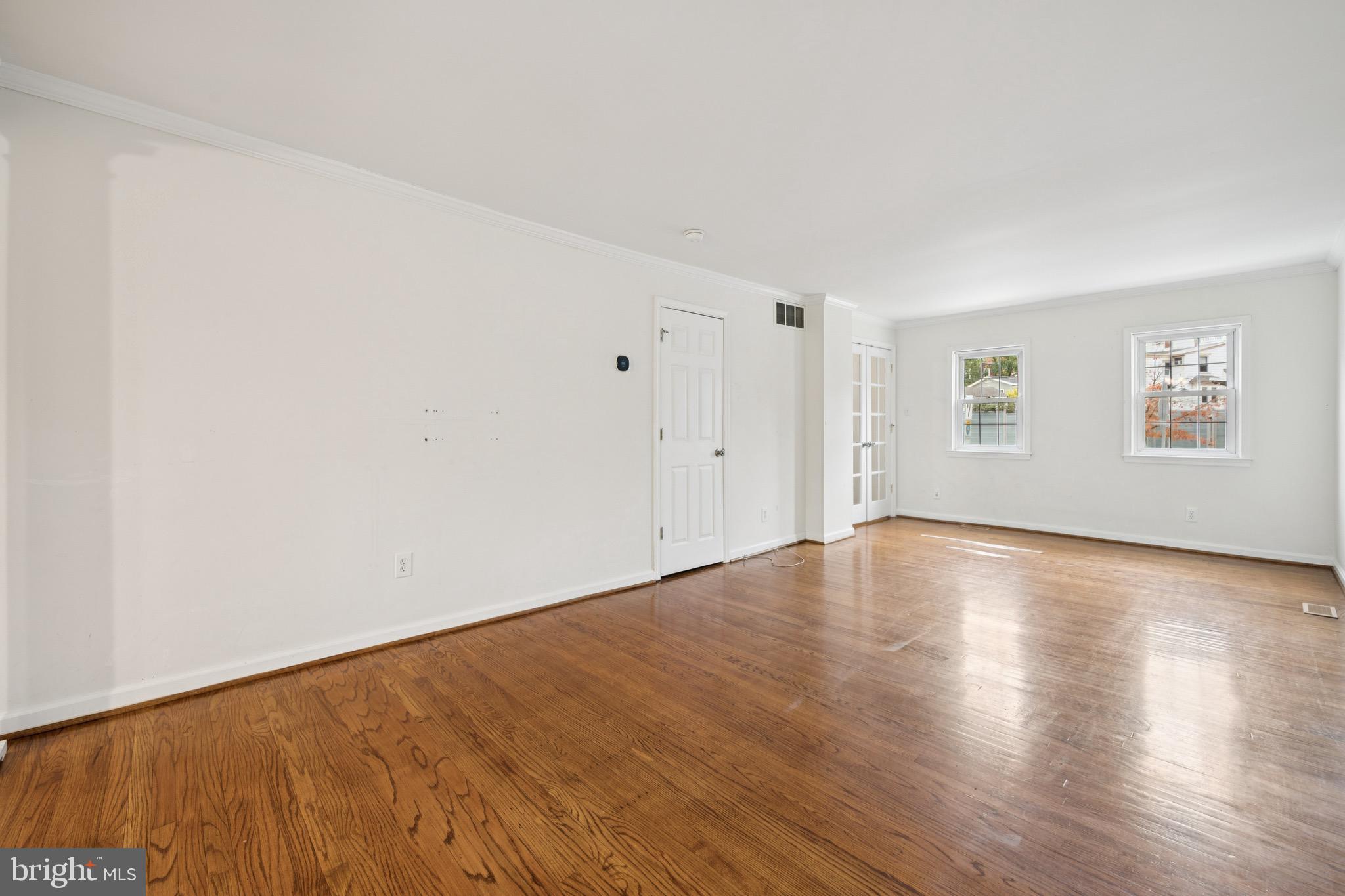 166 Ellis Street Haddonfield, NJ 08033 - Photo 9 of 25 an empty room with wooden floor and windows