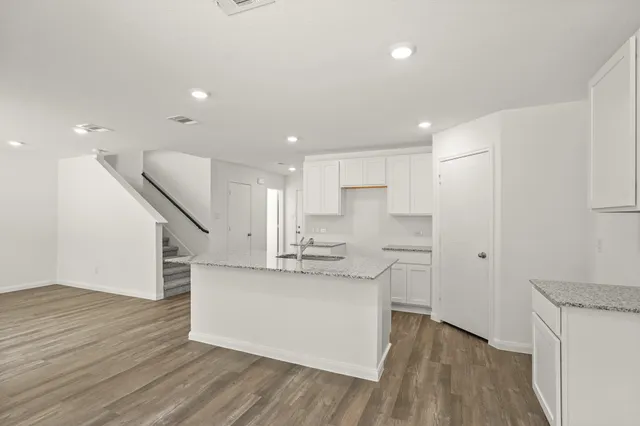 a kitchen with stainless steel appliances a refrigerator and a stove top oven