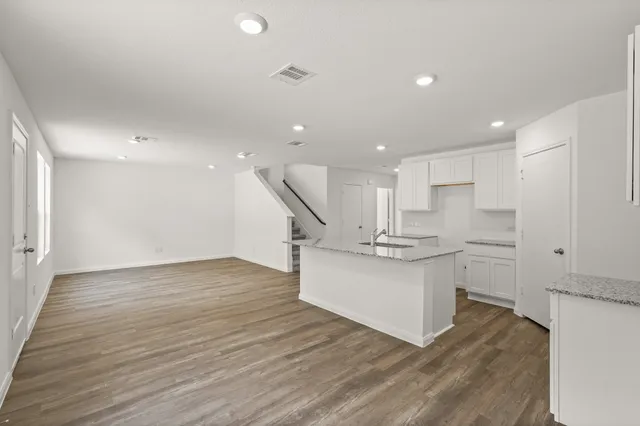 a kitchen with stainless steel appliances granite countertop a sink stove and a refrigerator