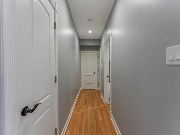 a view of a hallway with wooden floor