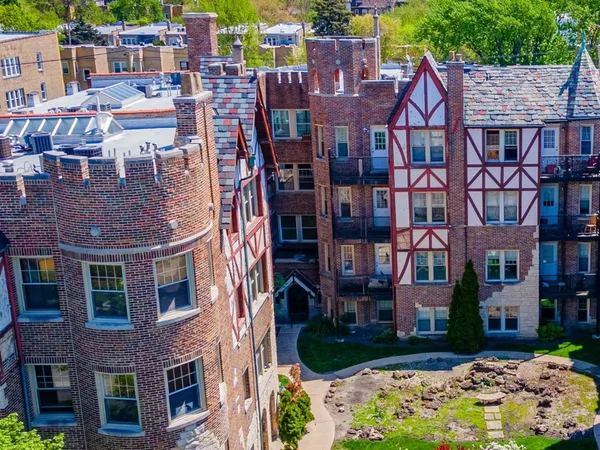 a front view of a building with garden and plants