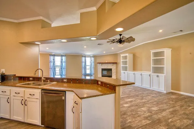 a view of an empty room with window and fire place