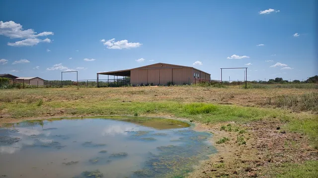 a view of an ocean beach and a big yard