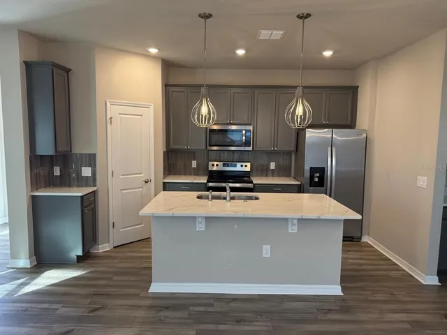 a kitchen with a sink and cabinets