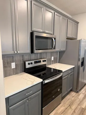 a stove top oven sitting inside of a kitchen