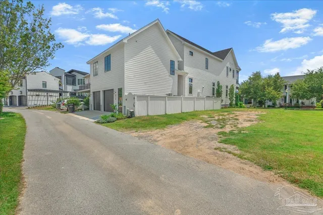 a view of a house with a yard and pathway