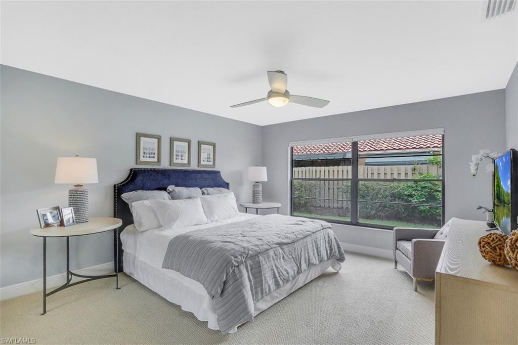 714 Reef Point Circle Naples, FL 34108 - Photo 11 of 27 a bedroom with a bed and a couch