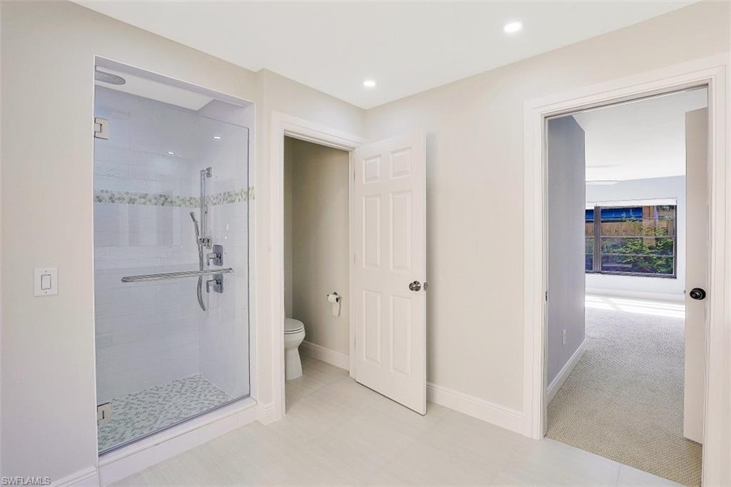 714 Reef Point Circle Naples, FL 34108 - Photo 13 of 27 a bathroom with a shower and a glass door