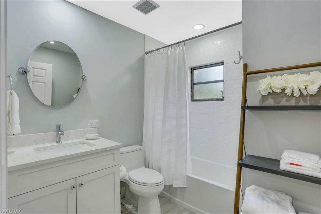 714 Reef Point Circle Naples, FL 34108 - Photo 15 of 27 a bathroom with a toilet sink and mirror