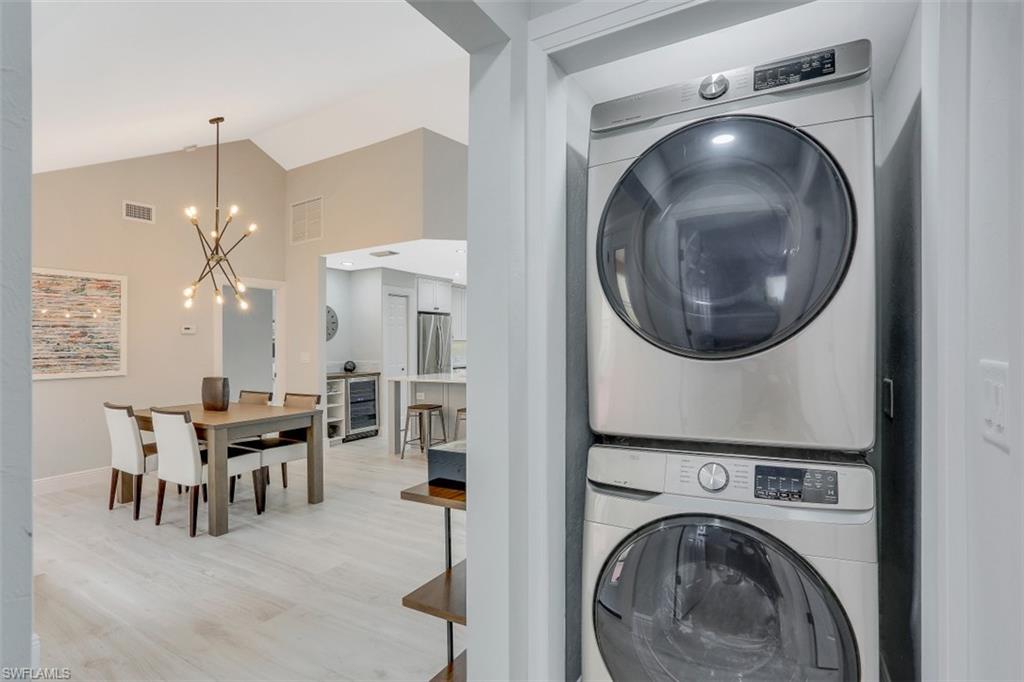 714 Reef Point Circle Naples, FL 34108 - Photo 16 of 27 a living room with furniture and a chandelier