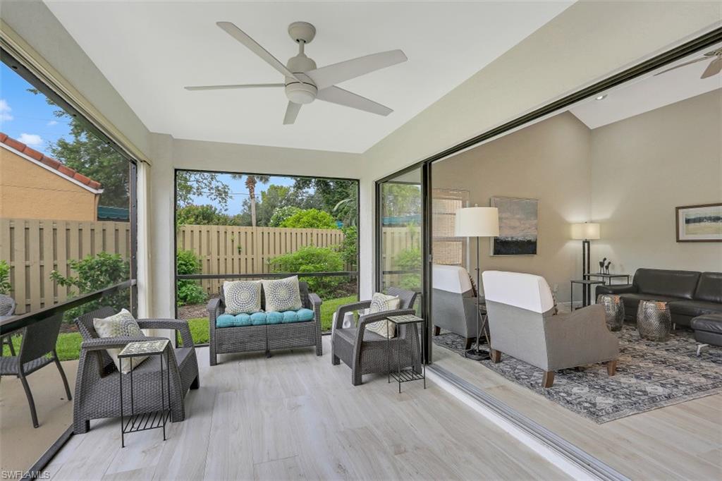 714 Reef Point Circle Naples, FL 34108 - Photo 17 of 27 a living room with furniture and a large window
