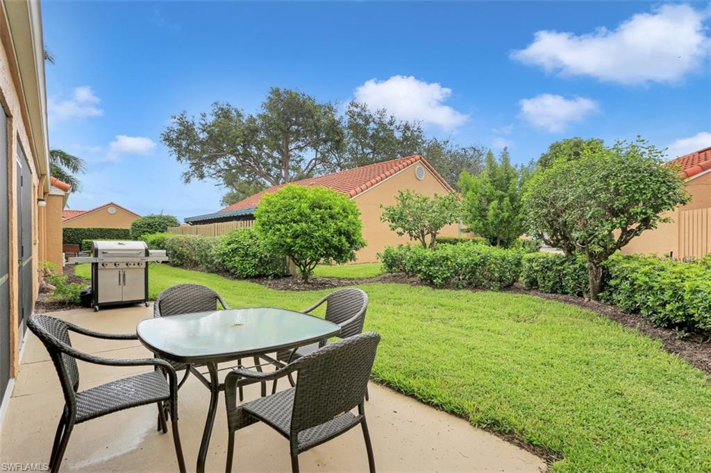 714 Reef Point Circle Naples, FL 34108 - Photo 19 of 27 a view of an chairs and table in the garden
