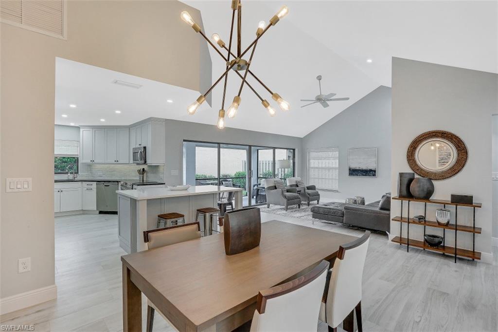 714 Reef Point Circle Naples, FL 34108 - Photo 2 of 27 a view of a dining room with furniture window and wooden floor