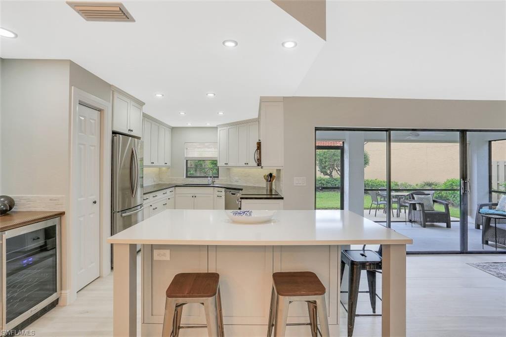 714 Reef Point Circle Naples, FL 34108 - Photo 4 of 27 a kitchen with stainless steel appliances a sink and a refrigerator