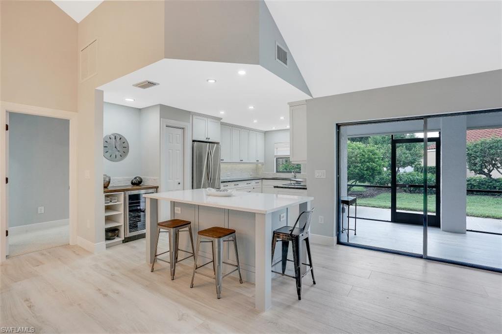 714 Reef Point Circle Naples, FL 34108 - Photo 6 of 27 a large kitchen with a table and chairs in it