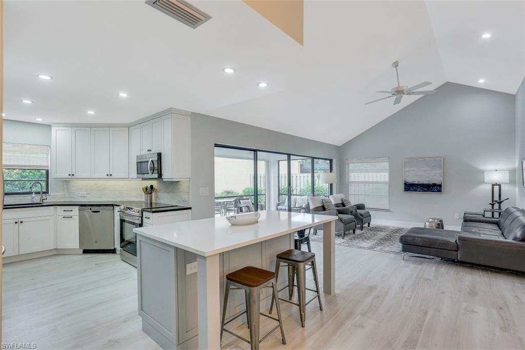 714 Reef Point Circle Naples, FL 34108 - Photo 8 of 27 a large kitchen with a table and chairs in it