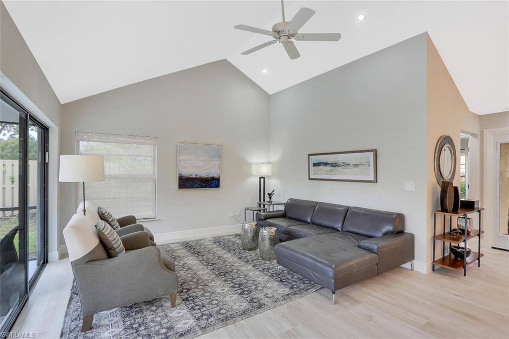 714 Reef Point Circle Naples, FL 34108 - Photo 9 of 27 a living room with furniture and a flat screen tv