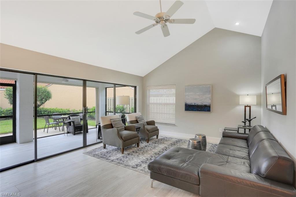 714 Reef Point Circle Naples, FL 34108 - Photo 10 of 27 a living room with furniture and a flat screen tv