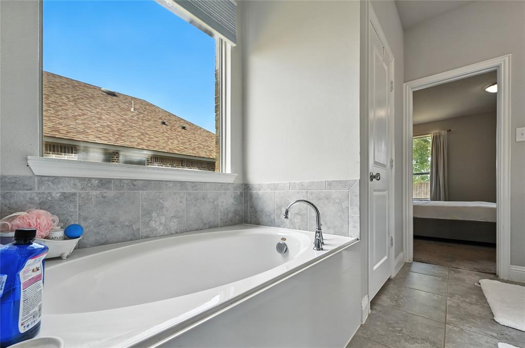 1160 Red Hawk Lane Forney, TX 75126 - Photo 11 of 33 a bathroom with a tub and shower