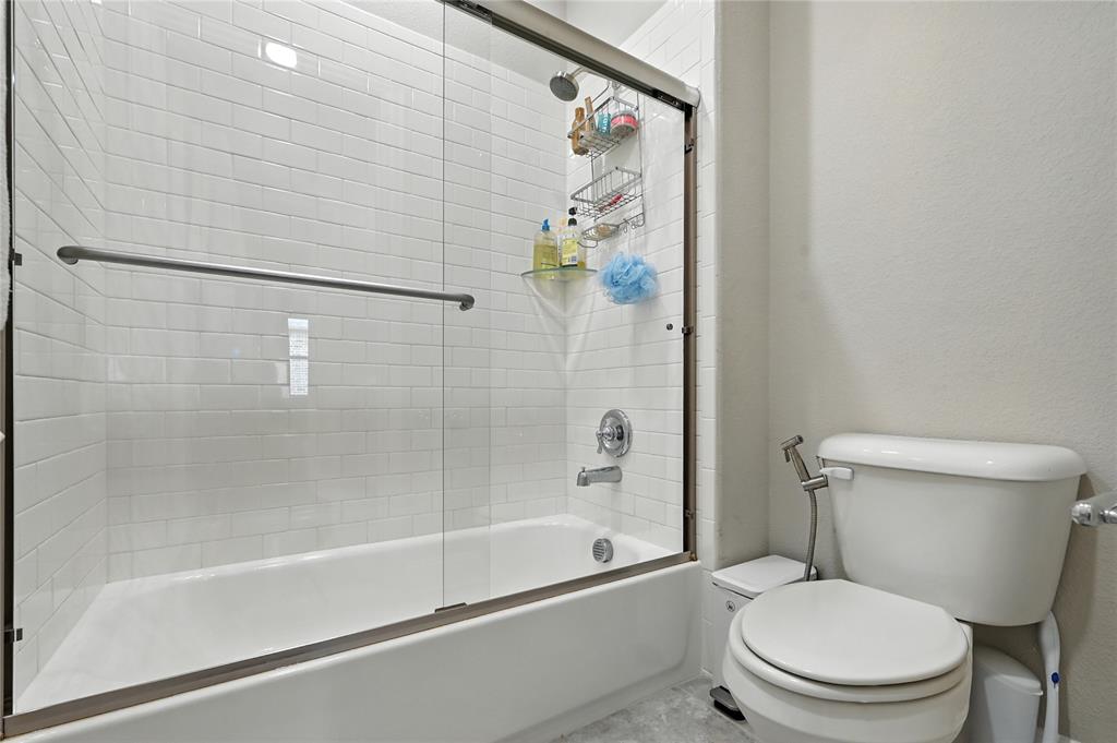 1160 Red Hawk Lane Forney, TX 75126 - Photo 19 of 33 a white toilet sitting next to a bath tub and a shower