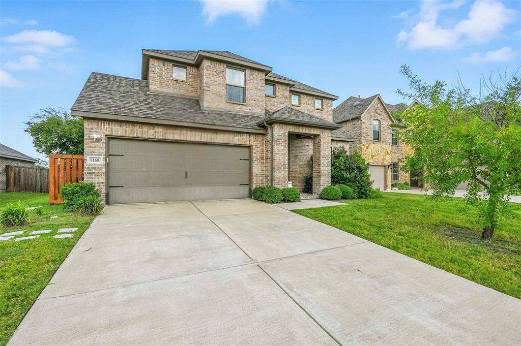 1160 Red Hawk Lane Forney, TX 75126 - Photo 2 of 33 a front view of a house with a yard and garage