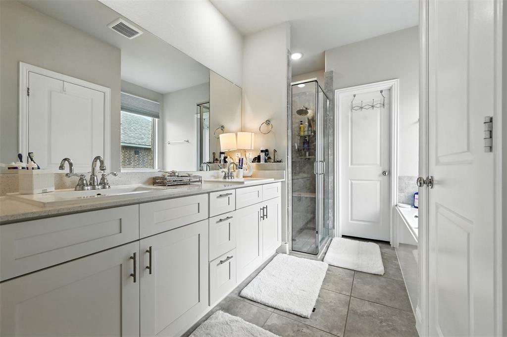 1160 Red Hawk Lane Forney, TX 75126 - Photo 10 of 33 a spacious bathroom with a shower sink and mirror