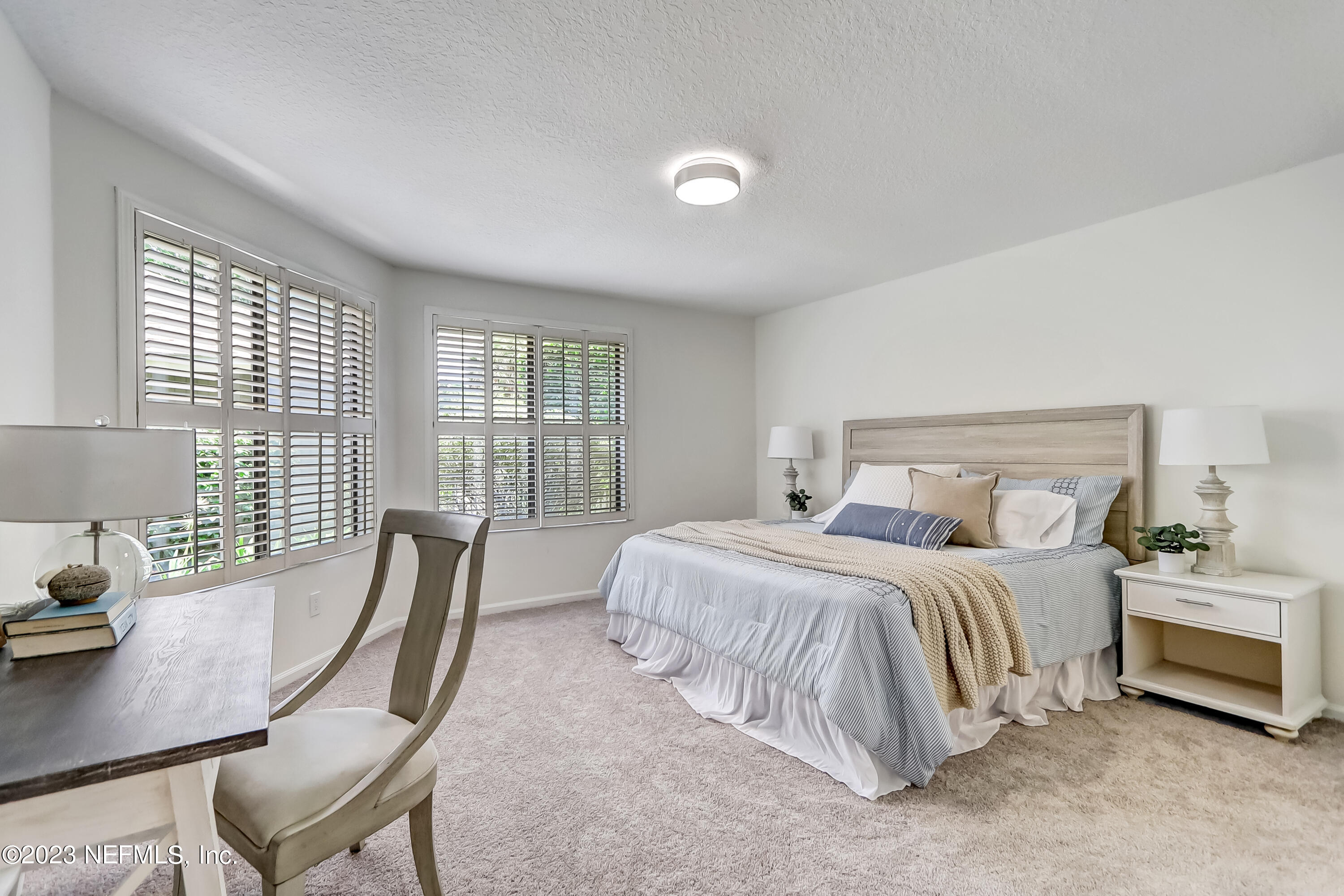 41 Turtleback Trail Ponte Vedra Beach, FL 32082 - Photo 18 of 41 a bedroom with a bed a large window with table and chair