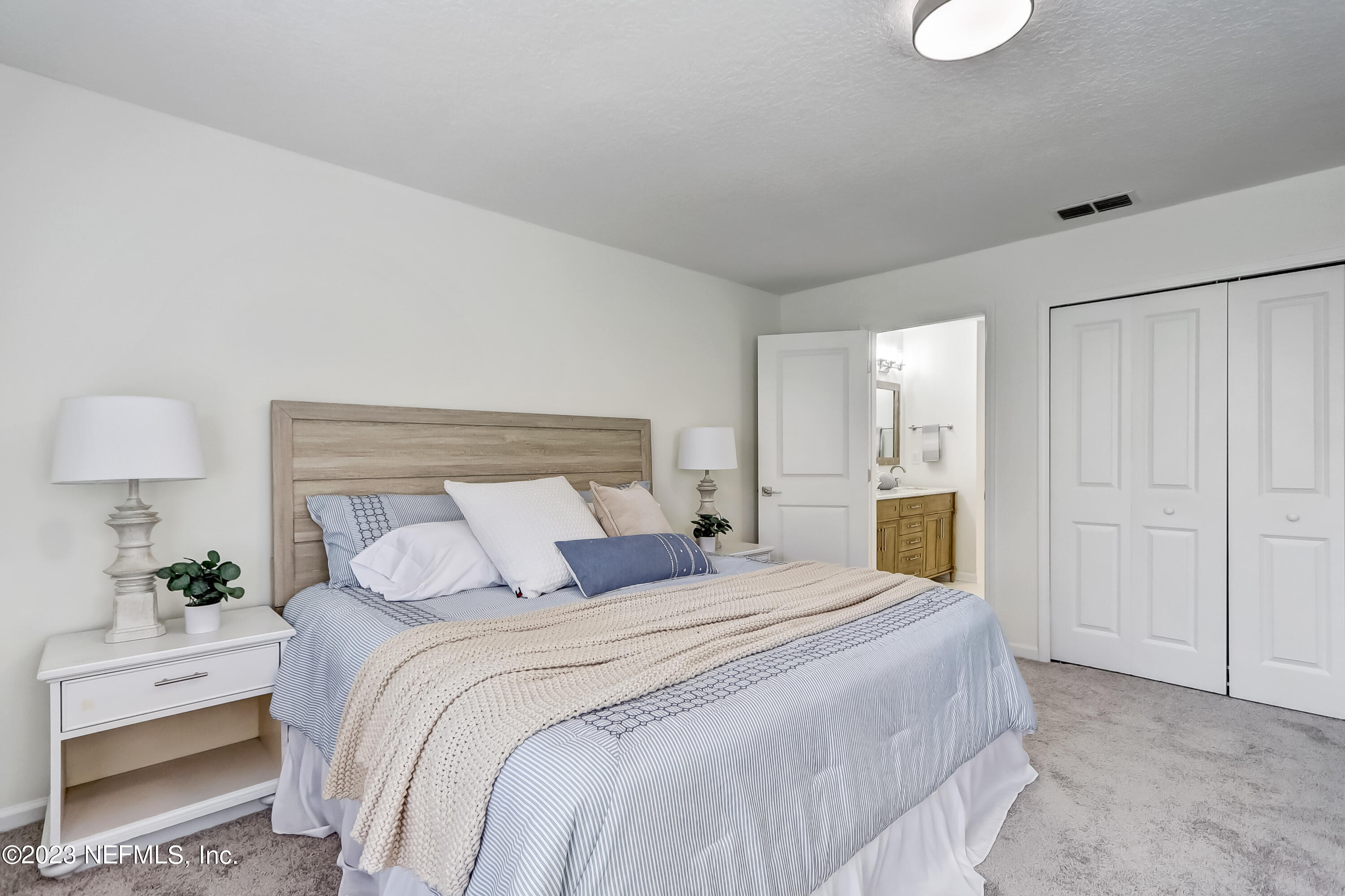 41 Turtleback Trail Ponte Vedra Beach, FL 32082 - Photo 19 of 41 a bedroom with a large bed and a potted plant