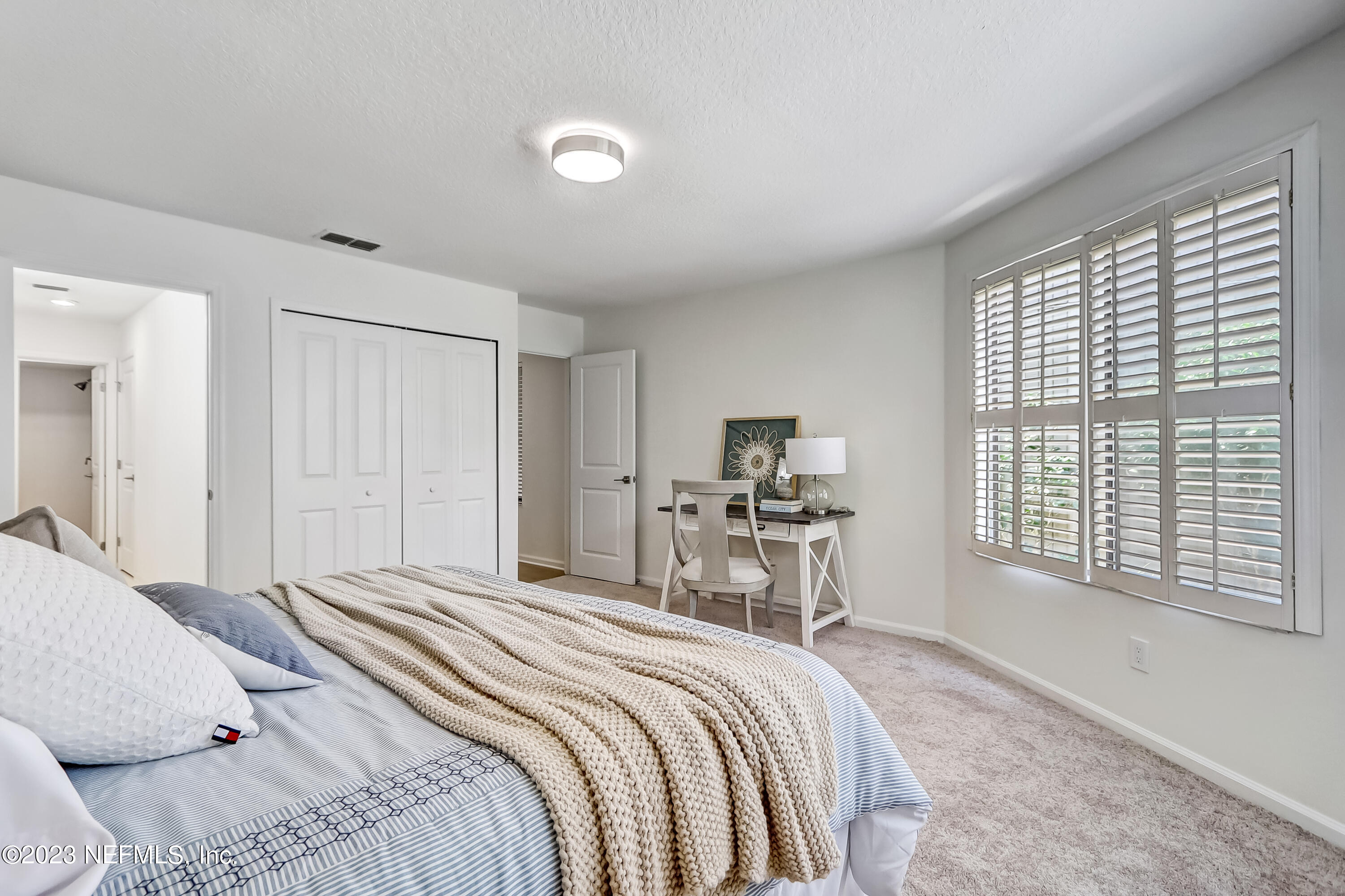 41 Turtleback Trail Ponte Vedra Beach, FL 32082 - Photo 20 of 41 a bedroom with a bed a large window and chair