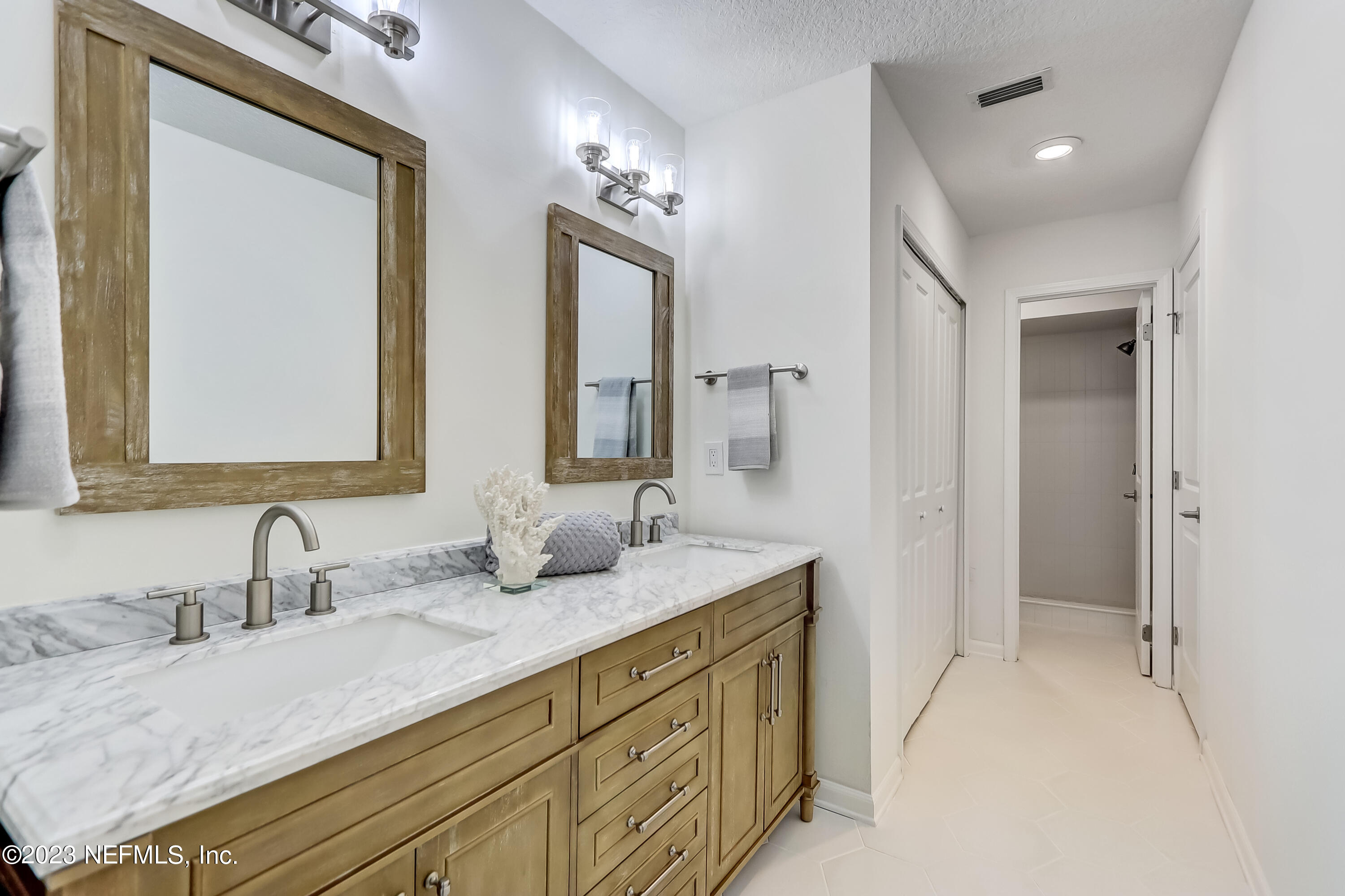 41 Turtleback Trail Ponte Vedra Beach, FL 32082 - Photo 22 of 41 a bathroom with double vanity sinks and a mirror