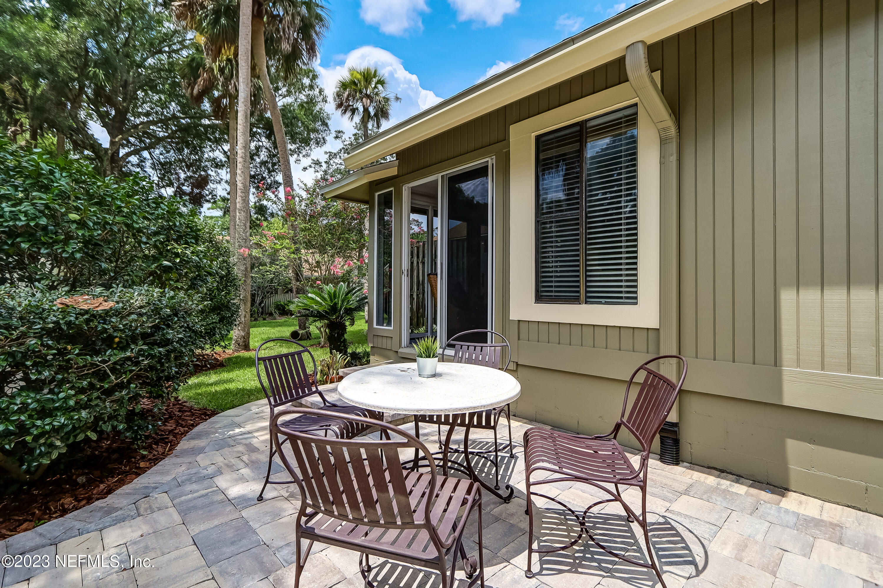 41 Turtleback Trail Ponte Vedra Beach, FL 32082 - Photo 36 of 41 a view of a patio with a table and chairs and a barbeque