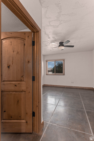 2464 East Granite Way St. George, UT 84790 - Photo 102 of 106 Hall looking into third bedroom featuring a textured ceiling and finished concrete floors